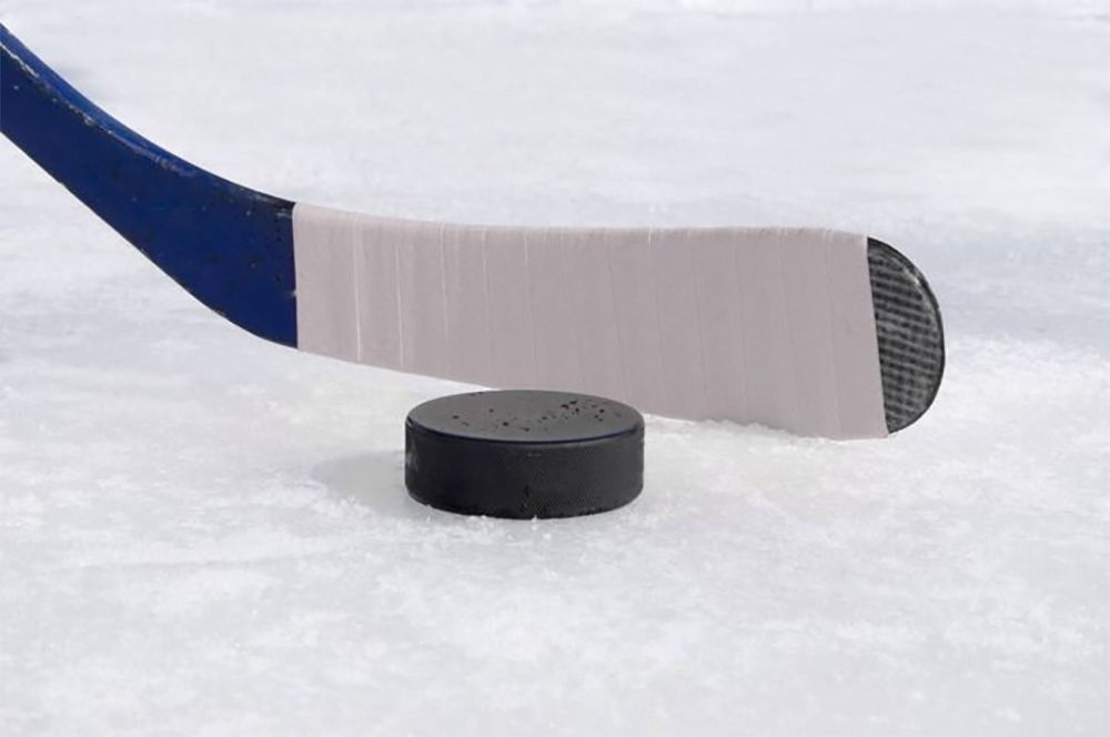 https://www.crosslinkcountysportsplex.com/wp-content/uploads/2021/12/stickandpuck.jpg https://www.crosslinkcountysportsplex.com/ A close view of ice hockey stick next to a puck on an ice rink.